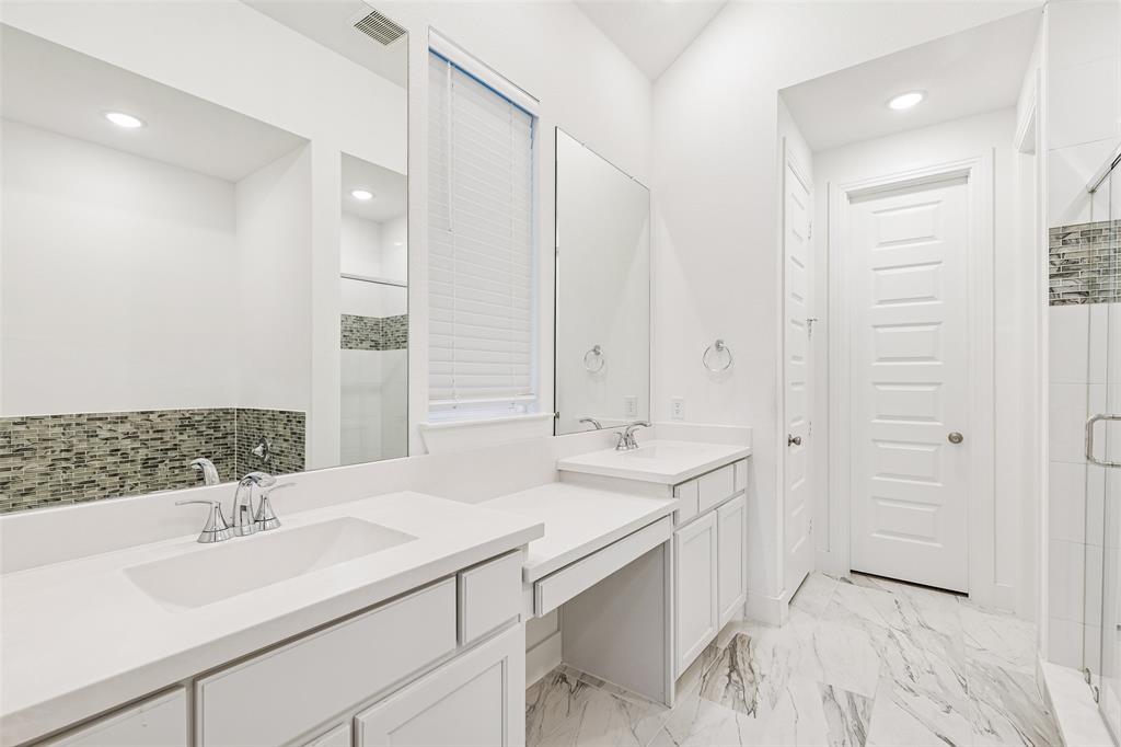 1144 Saddle Ridge Drive Aubrey, TX 76227 - Photo 15 of 34 a bathroom with double sink and a mirror
