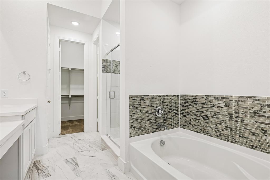 1144 Saddle Ridge Drive Aubrey, TX 76227 - Photo 16 of 34 a bathroom with bathtub and shower