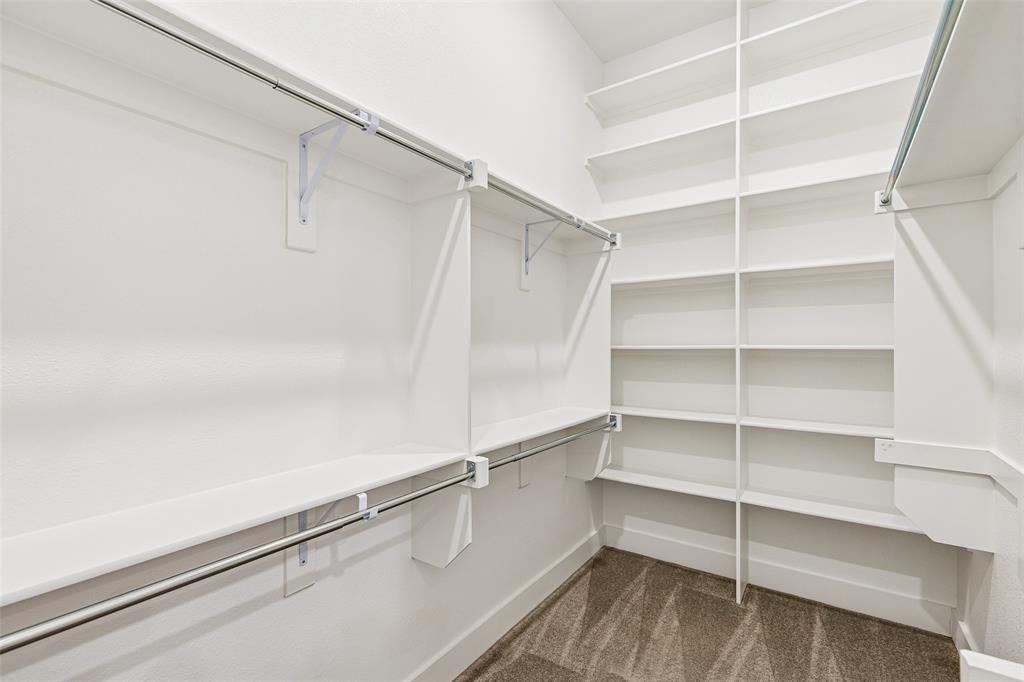 1144 Saddle Ridge Drive Aubrey, TX 76227 - Photo 17 of 34 a view of walk in closet with empty racks