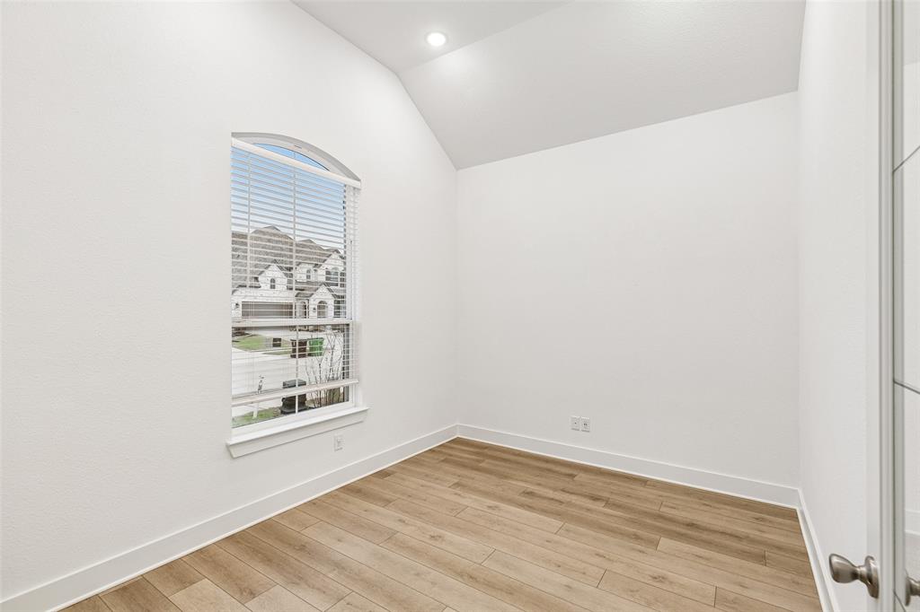 1144 Saddle Ridge Drive Aubrey, TX 76227 - Photo 19 of 34 a view of an empty room with wooden floor and a window