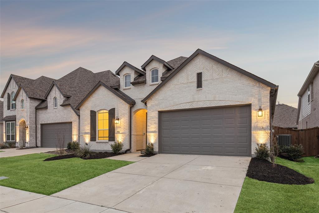1144 Saddle Ridge Drive Aubrey, TX 76227 - Photo 2 of 34 a front view of a house with a yard and garage