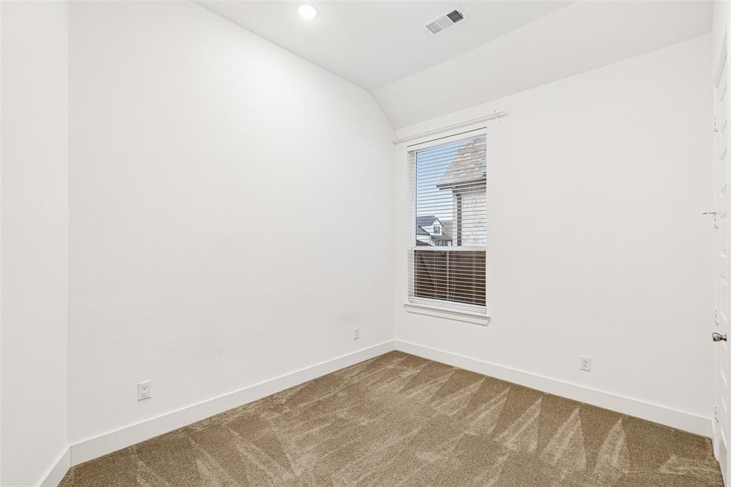 1144 Saddle Ridge Drive Aubrey, TX 76227 - Photo 22 of 34 a view of an empty room with wooden floor and a window