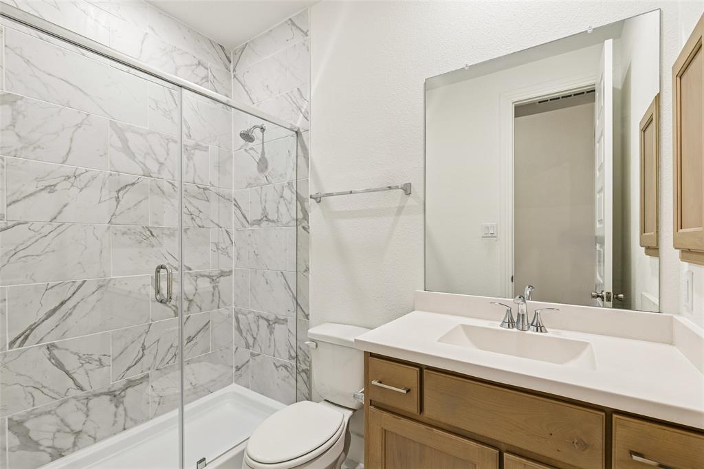 1144 Saddle Ridge Drive Aubrey, TX 76227 - Photo 23 of 34 a bathroom with a sink toilet and shower