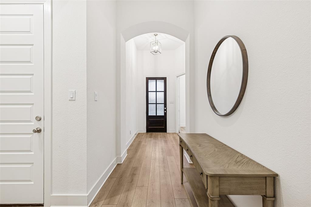 1144 Saddle Ridge Drive Aubrey, TX 76227 - Photo 26 of 34 a front view of a house with hallway