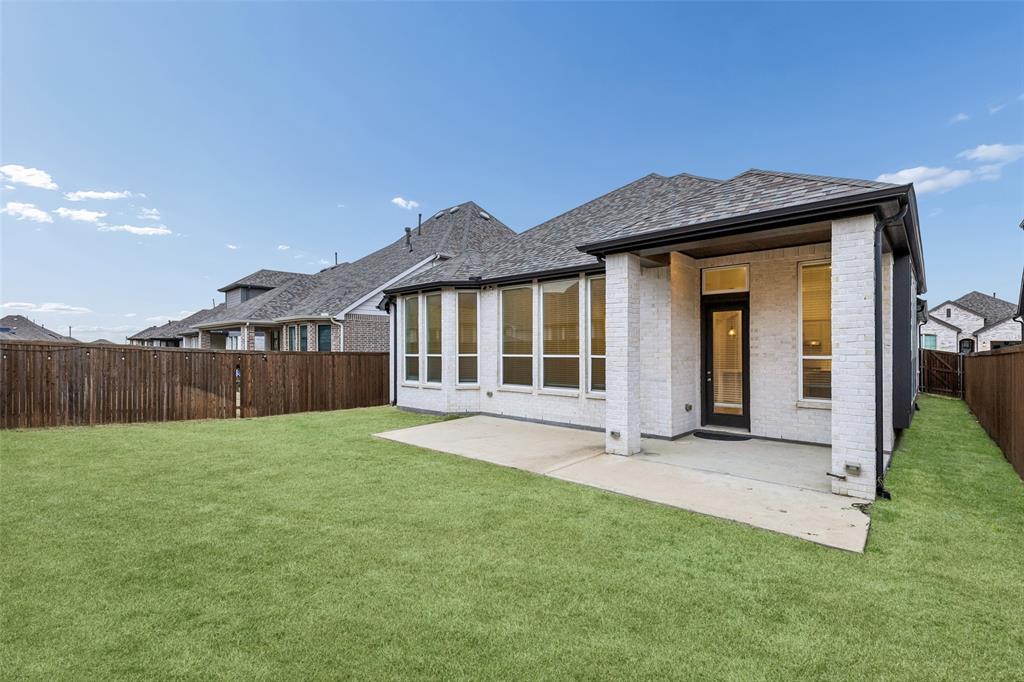 1144 Saddle Ridge Drive Aubrey, TX 76227 - Photo 32 of 34 a view of a house with a yard and porch