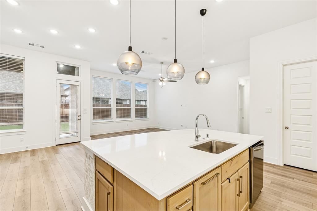 1144 Saddle Ridge Drive Aubrey, TX 76227 - Photo 5 of 34 a kitchen with center island stainless steel appliances and wooden floor