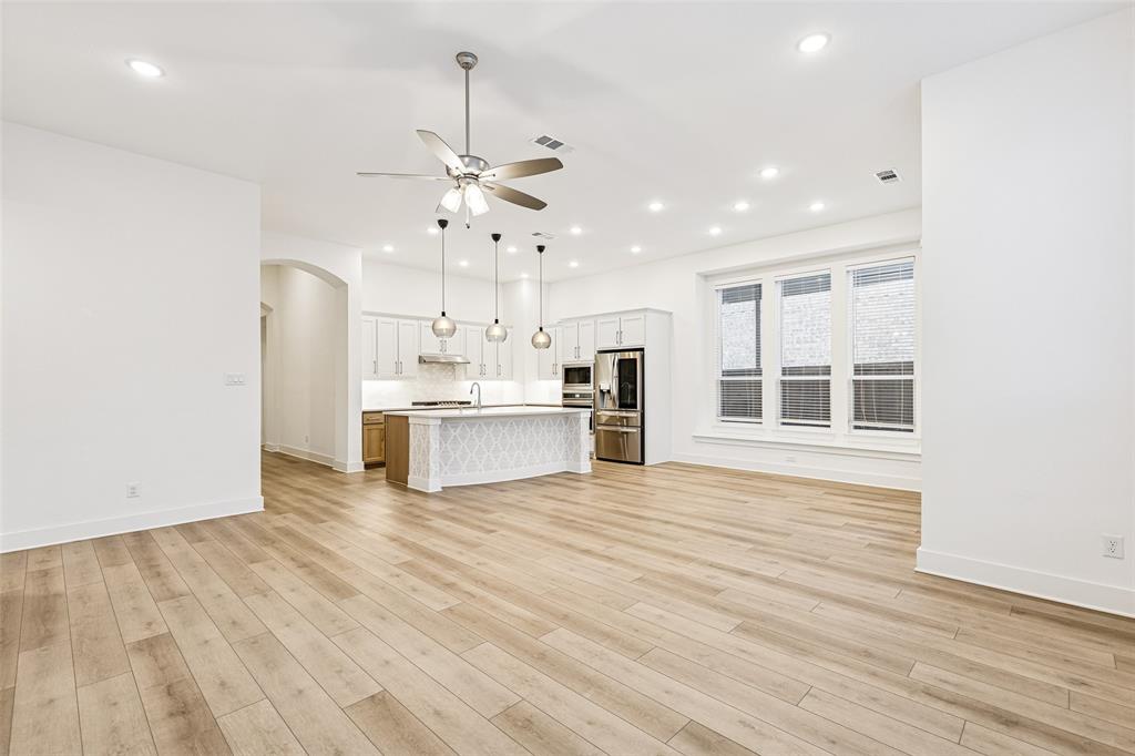 1144 Saddle Ridge Drive Aubrey, TX 76227 - Photo 8 of 34 a view of kitchen with granite countertop cabinets and refrigerator