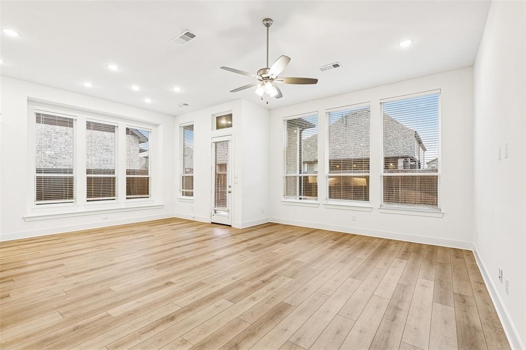 1144 Saddle Ridge Drive Aubrey, TX 76227 - Photo 9 of 34 a view of an empty room with wooden floor and a window