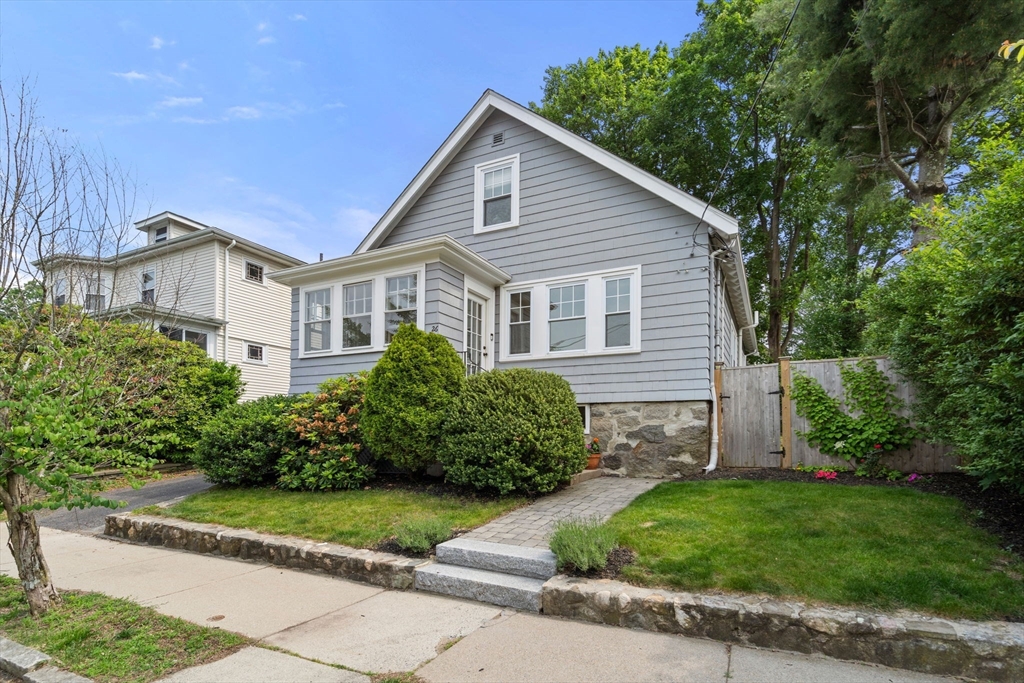 a front view of a house with a garden
