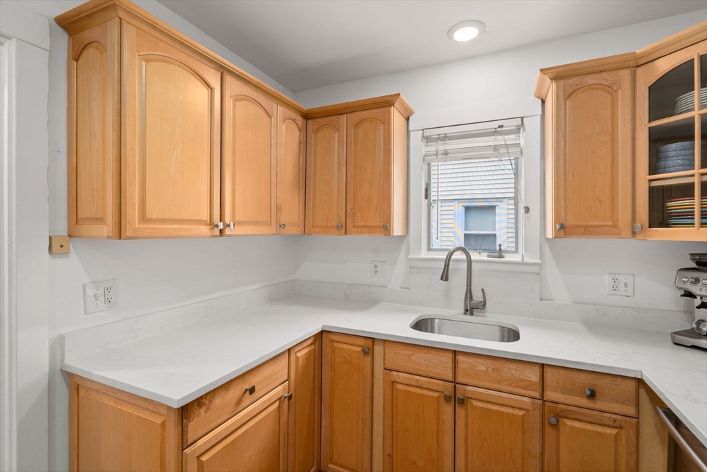 26 Edgebrook Road Boston, MA 02132 - Photo 13 of 30 a kitchen with stainless steel appliances a sink cabinets and a window