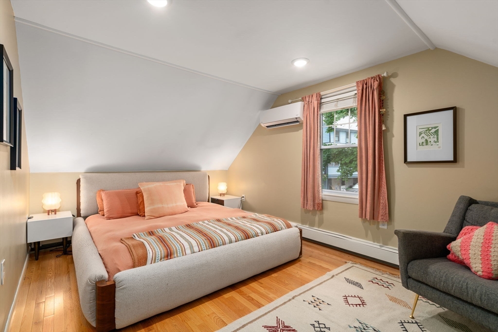 26 Edgebrook Road Boston, MA 02132 - Photo 17 of 30 a bedroom with a bed couch and a large window