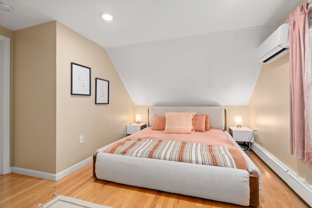 26 Edgebrook Road Boston, MA 02132 - Photo 18 of 30 a bedroom with a large bed and wooden floor