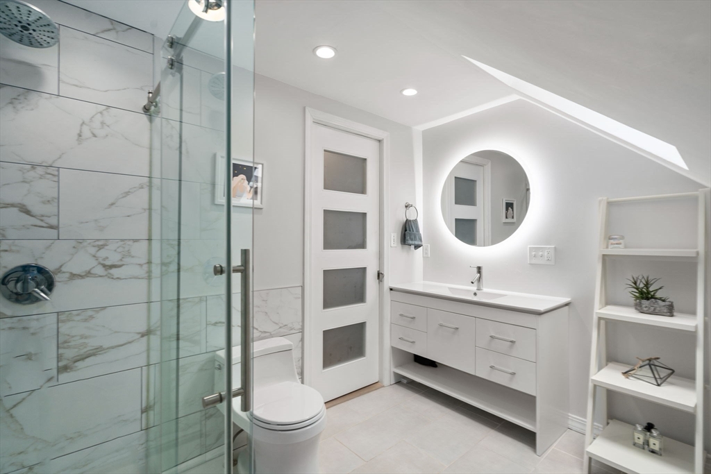 26 Edgebrook Road Boston, MA 02132 - Photo 23 of 30 a bathroom with a double vanity sink toilet mirror and shower