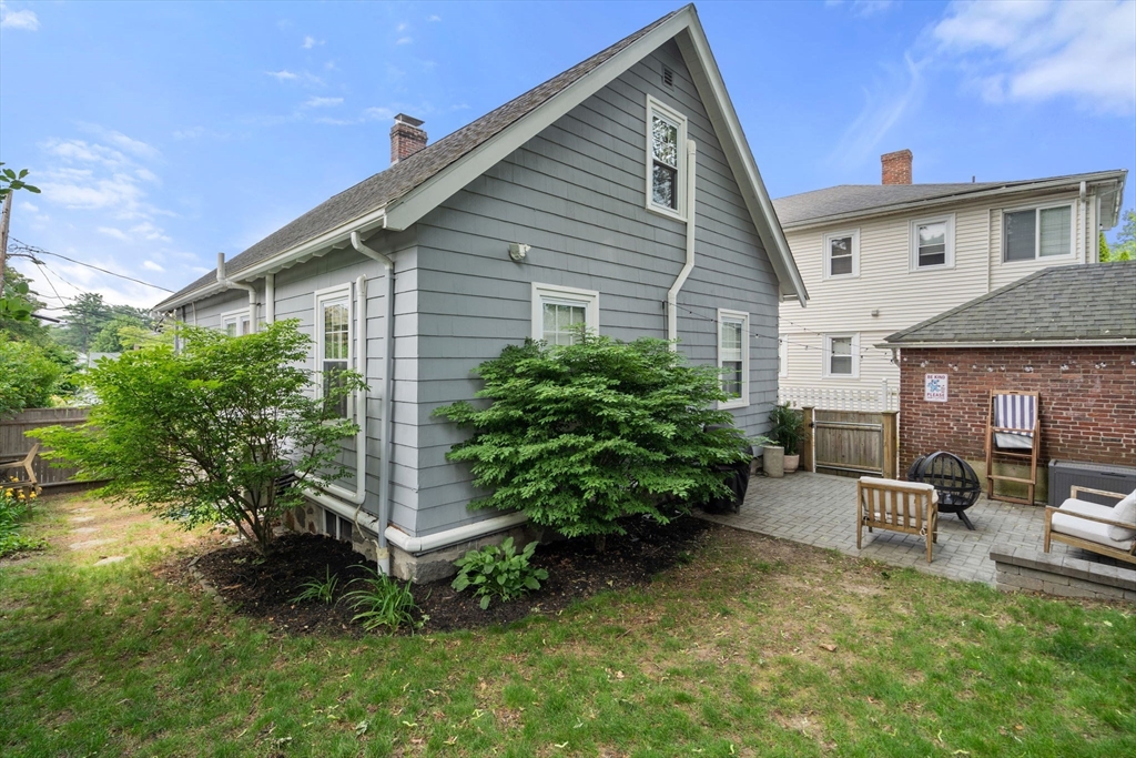26 Edgebrook Road Boston, MA 02132 - Photo 28 of 30 a backyard of a house with plants and outdoor seating