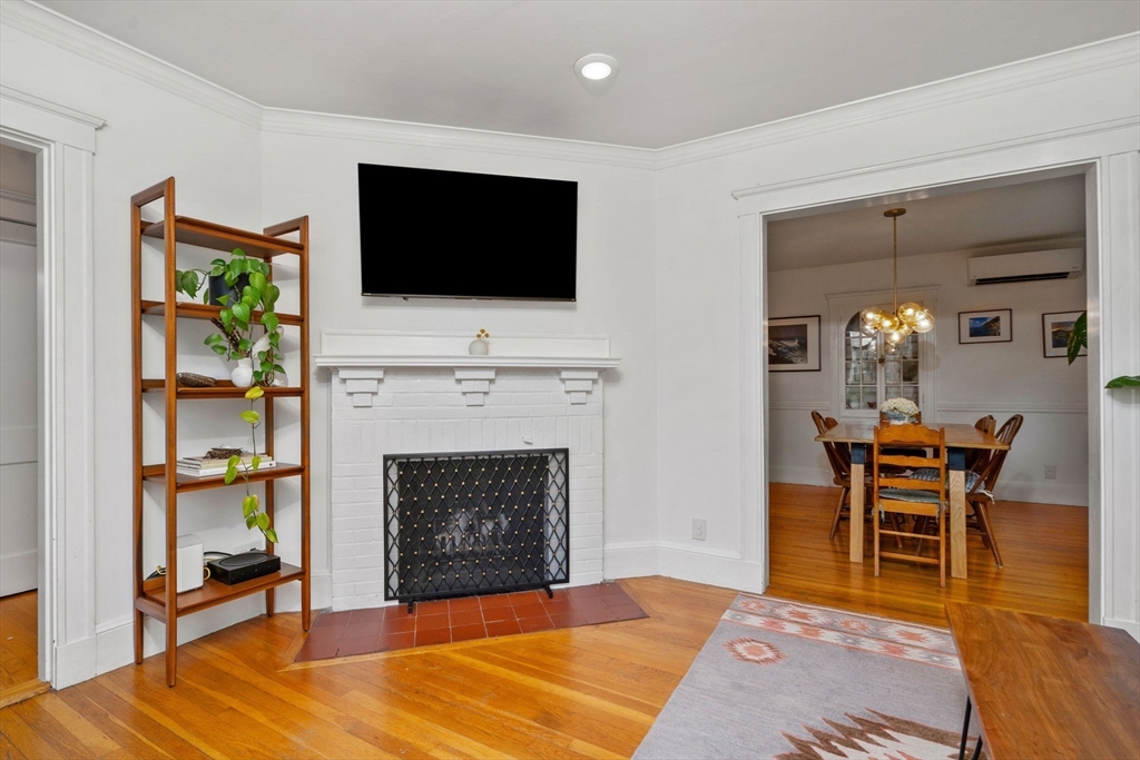 26 Edgebrook Road Boston, MA 02132 - Photo 4 of 30 a living room with furniture a flat screen tv and a fireplace