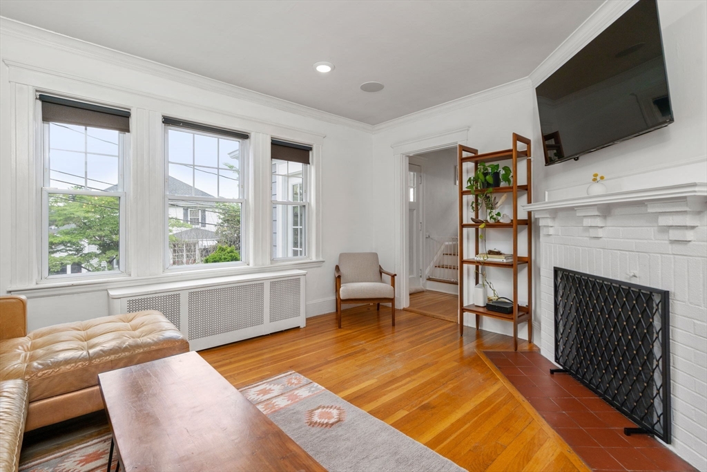 26 Edgebrook Road Boston, MA 02132 - Photo 5 of 30 a living room with furniture a flat screen tv and a fireplace