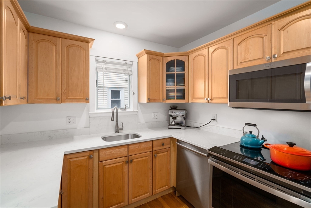 26 Edgebrook Road Boston, MA 02132 - Photo 10 of 30 a kitchen with stainless steel appliances granite countertop a sink stove and microwave