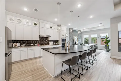 a kitchen with stainless steel appliances kitchen island a large island in the center