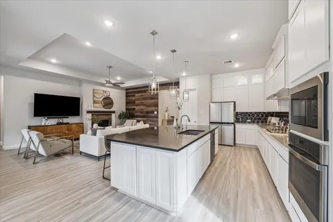 a large kitchen with stainless steel appliances lots of counter top space