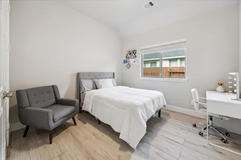 a bedroom with a bed and a couch