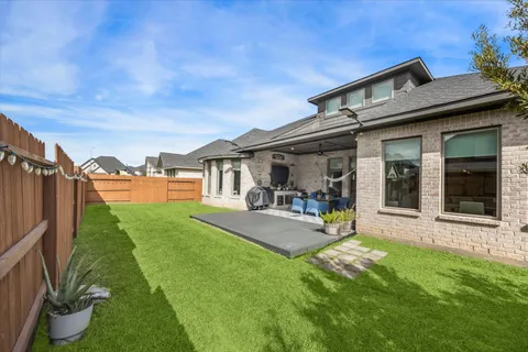 a view of a house with backyard porch and sitting area