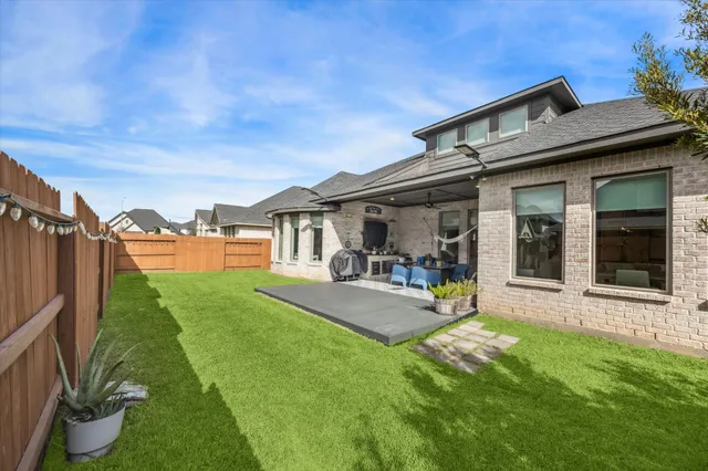 a view of a house with backyard porch and sitting area