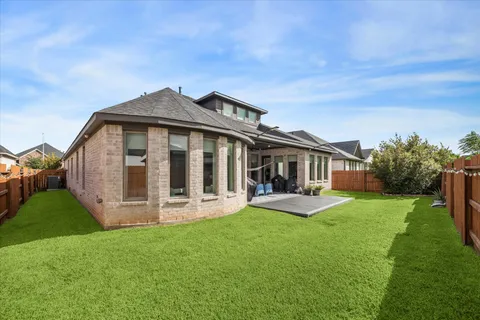 a view of a house with a yard and sitting area
