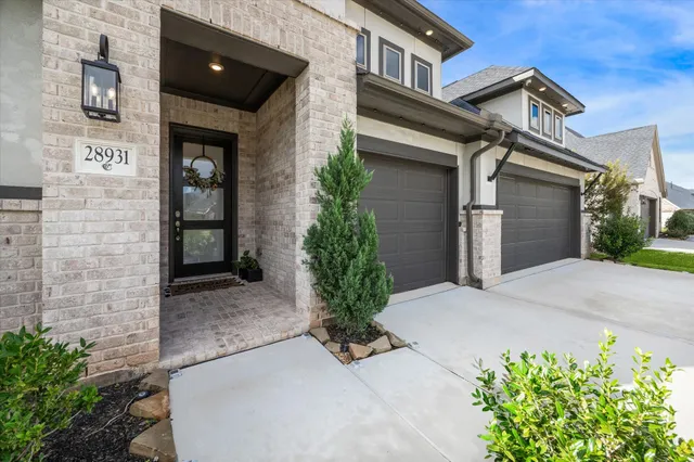 a view of a house with potted plants