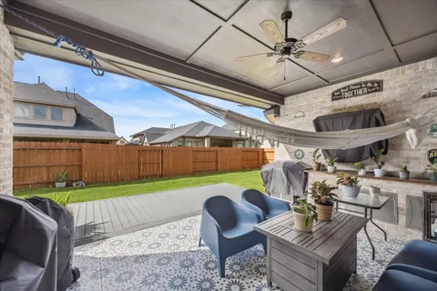 a roof deck with table and chairs and a barbeque