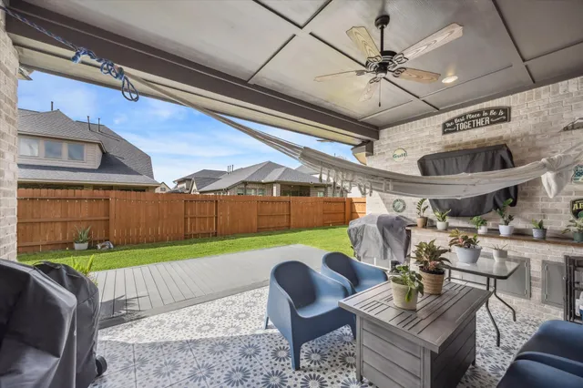 a roof deck with table and chairs and a barbeque