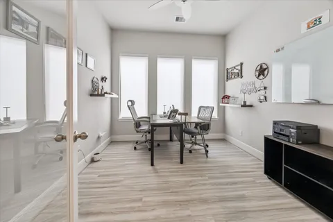 a view of a a dining room with furniture window and wooden floor
