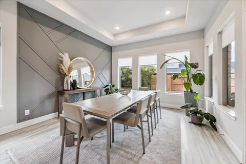 a view of a dining room with furniture a livingroom and chandelier