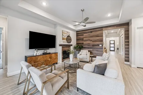 a living room with fireplace furniture and a flat screen tv