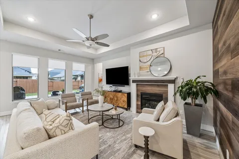 a living room with furniture a fireplace and a flat screen tv