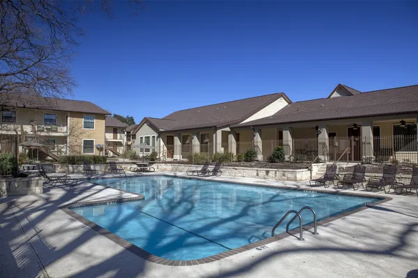 a view of a house with swimming pool and sitting area