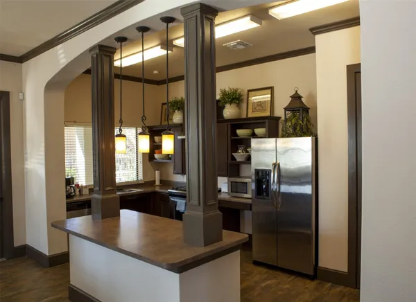 a kitchen with stainless steel appliances granite countertop a refrigerator a stove and a sink