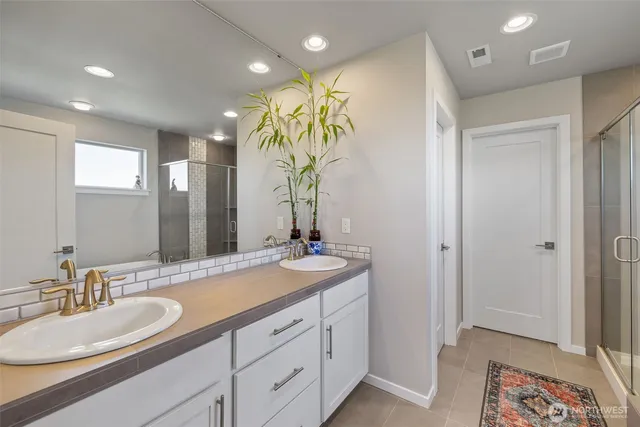 a bathroom with a double vanity sink and a mirror