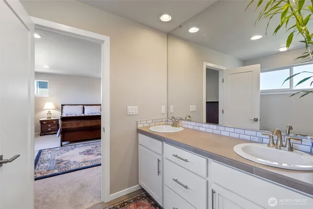 a en suite bathroom with double sink and a mirror