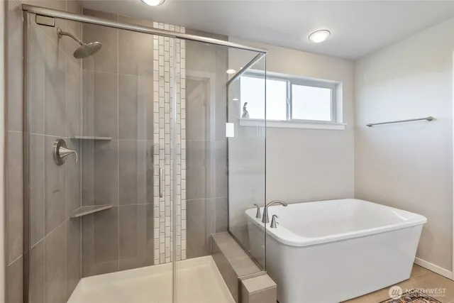 a bathroom with a bathtub and a shower