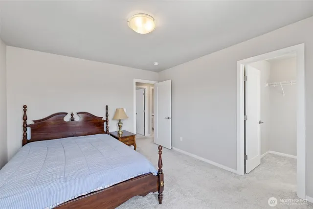 a bedroom with a bed and a lamp