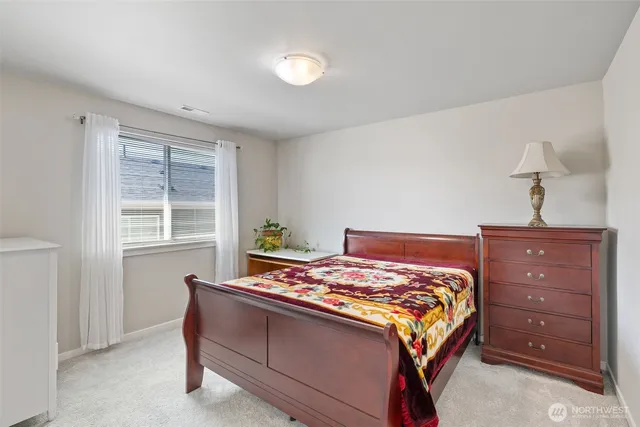 a bedroom with a bed and window