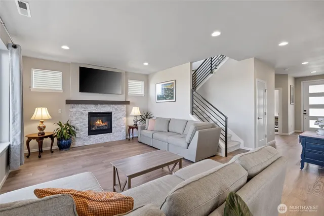 a living room with furniture fireplace and flat screen tv