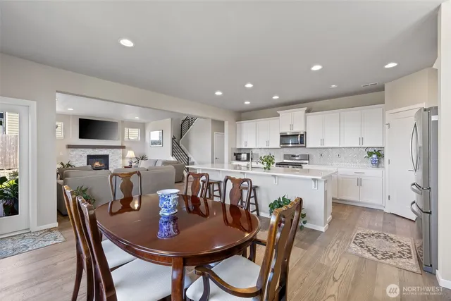 a view of kitchen with cabinets table and chairs
