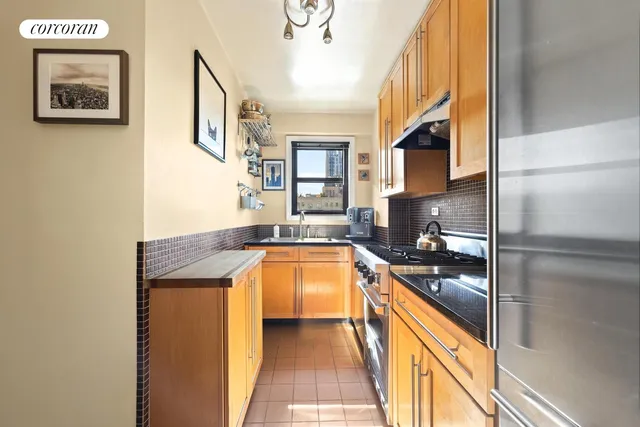 a kitchen with stainless steel appliances granite countertop a refrigerator and a sink