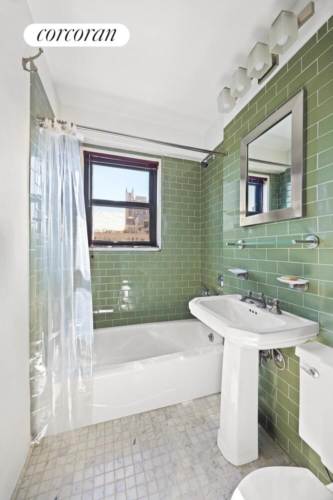 201 West 21st Street, Unit 14F Manhattan, NY 10011 - Photo 6 of 10 a bathroom with a sink a toilet and shower