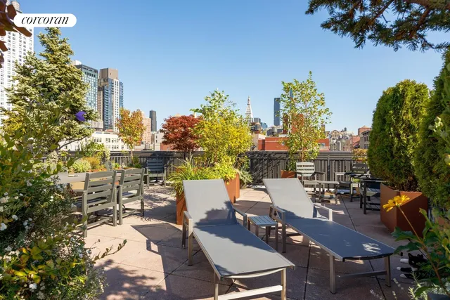 a view of a patio with table and chairs and potted plants