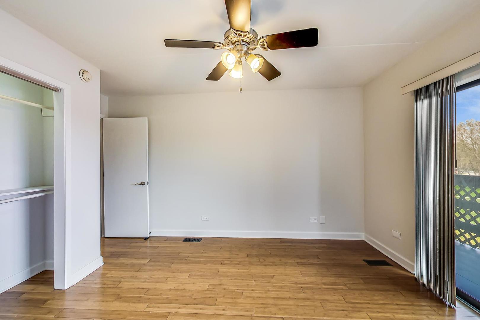 102 Kenneth Circle Elgin, IL 60120 - Photo 13 of 33 a view of an empty room with window and wooden floor