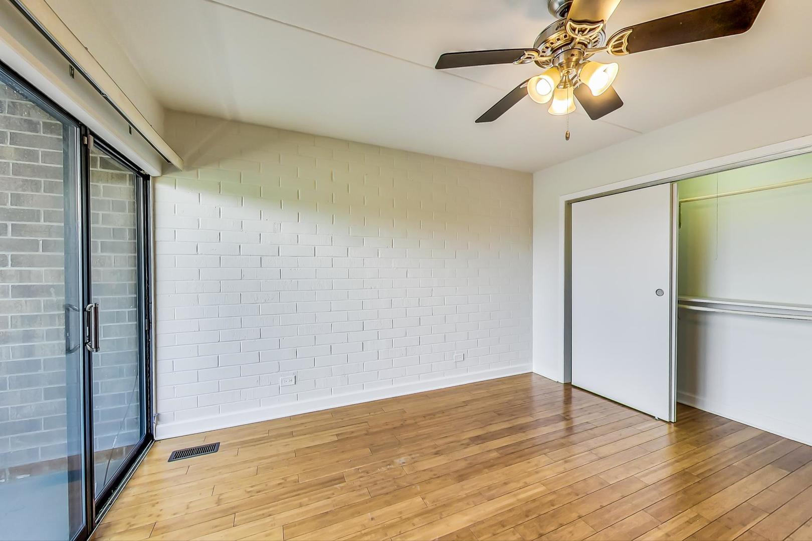 102 Kenneth Circle Elgin, IL 60120 - Photo 14 of 33 a view of empty room with wooden floor and fan