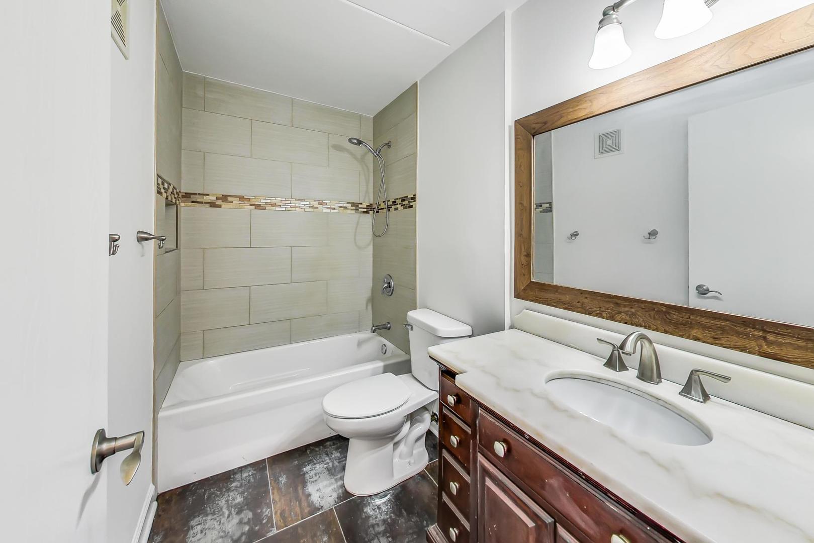 102 Kenneth Circle Elgin, IL 60120 - Photo 15 of 33 a bathroom with a sink and a mirror