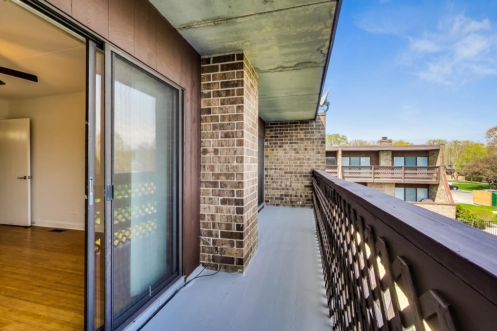 102 Kenneth Circle Elgin, IL 60120 - Photo 18 of 33 a view of balcony with wooden floor and seating space